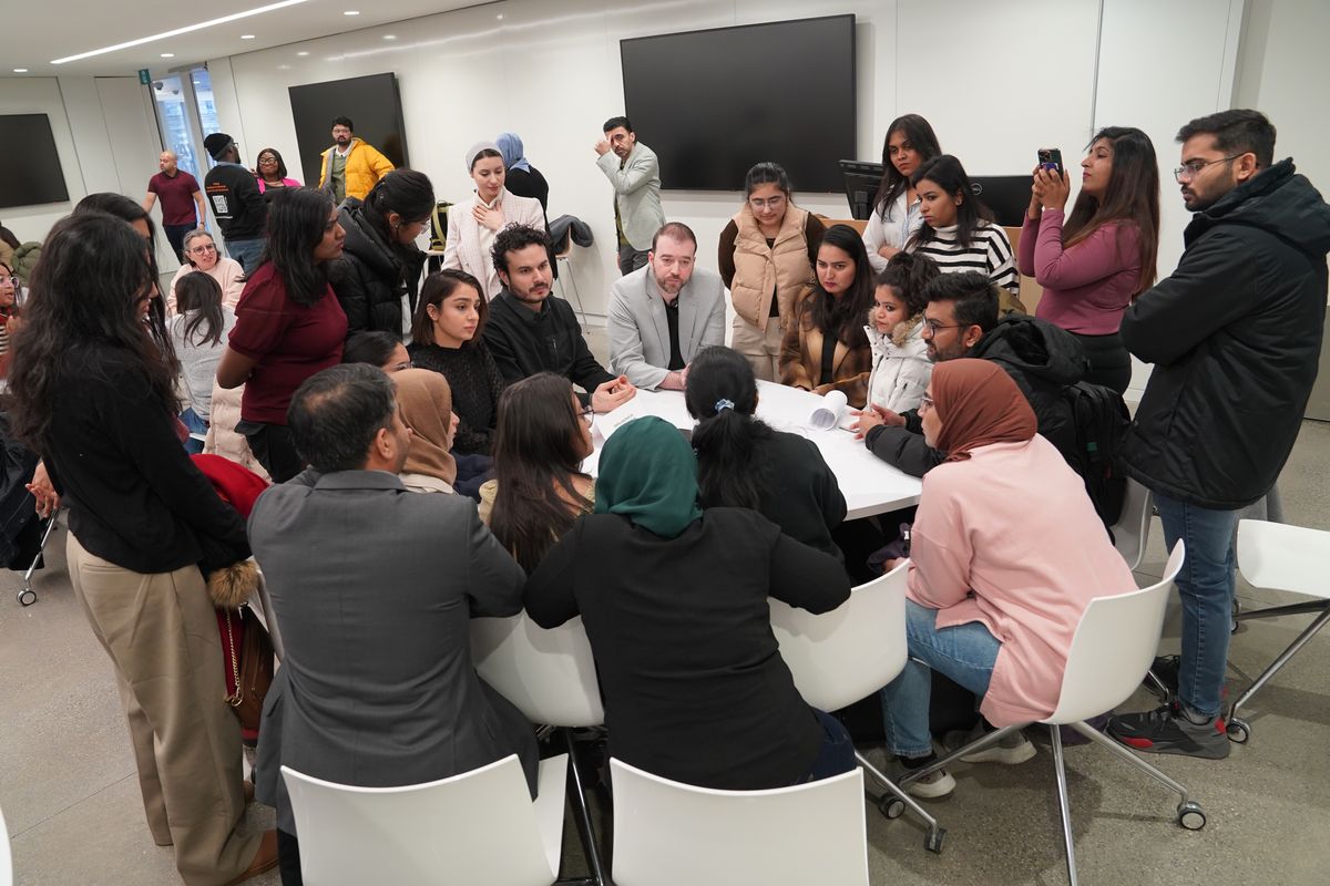 Community members taking part in a facilitated round-table discussion